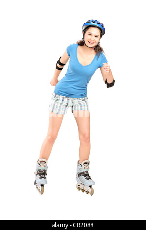 Portrait d'une fille sur rouleaux skating isolé sur fond blanc Banque D'Images