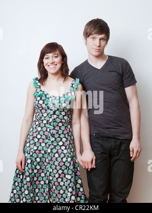 Happy young couple posing in studio Banque D'Images