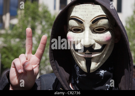 'Anonyme' occuper le port d'un manifestant Guy Fawkes ou Masque V pour Vendetta lors d'une manifestation à Londres Banque D'Images