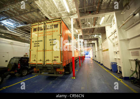 Conteneurs à marchandises sur le pont des véhicules d'un ferry moderne dans la nuit dans le port de Belfast Irlande du Nord uk Banque D'Images