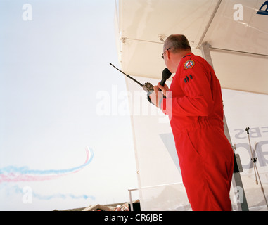 Commentateur au sol de pilote les flèches rouges, la RAF aerobatic team diffuse l'affichage de 30 min au cours de l'aéronautique. Banque D'Images