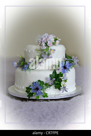 Gâteau de mariage avec des fleurs bleu lilas et Banque D'Images