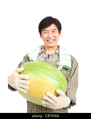 Happy middle aged asian farmer holding big watermelon Banque D'Images