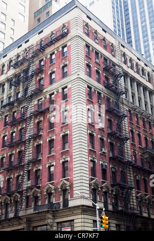 L'extérieur du bâtiment typique en plein centre de Manhattan, New York City avec fer forgé fire s'échappe à l'extérieur Banque D'Images