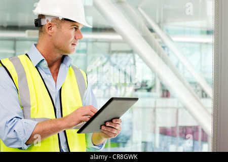 Engineer using digital tablet in office Banque D'Images