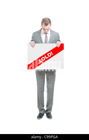 Un homme d'affaires avec un sold sign Banque D'Images
