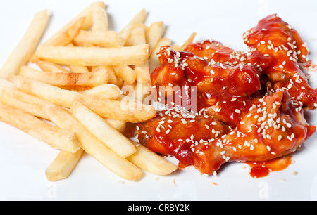 Les cuisses de poulet et des frites en sauce tomate Banque D'Images