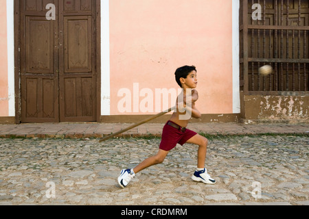 Garçon jouant au baseball dans les rues de la vieille ville de Trinidad, Cuba Banque D'Images