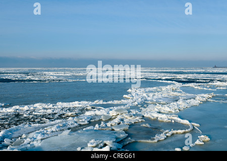 Frozen Mer du Nord avec le phare de Hallig Langeness, Holm, à l'horizon, la Frise du Nord, Schleswig-Holstein Banque D'Images