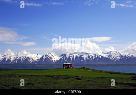 Chalet en bois sur les rives de l'Eyjafjordur avec les montagnes derrière Kaldbakur, Islande, Dalvik Banque D'Images