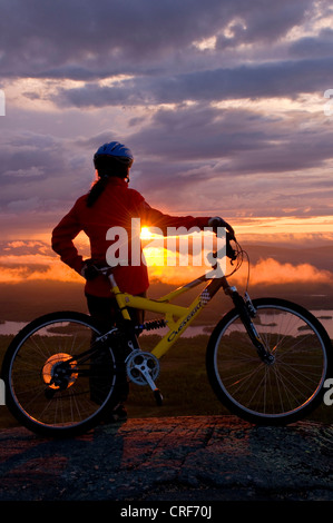 Vélo de montagne femelle sous le soleil de minuit, la Suède, la Laponie, Gaellivare Banque D'Images