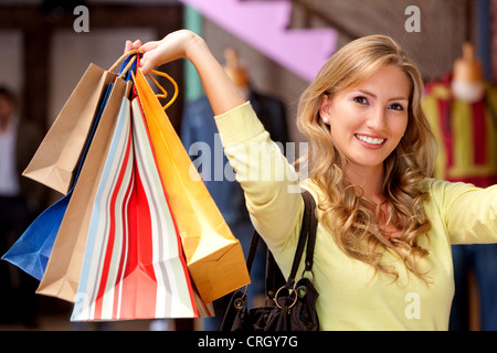 Casual woman with shopping bags smiling Banque D'Images