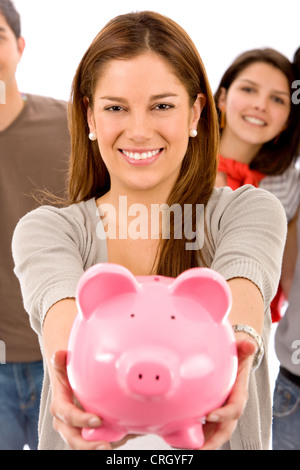 Woman holding a piggy bank vers l'appareil photo Banque D'Images