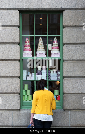 Femme à la recherche de la fenêtre de Laduree shop. Covent Garden, Londres, Angleterre Banque D'Images