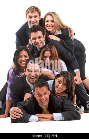 Group of smiling jeunes gens d'affaires se trouvant sur le plancher empilés Banque D'Images