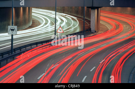 Sentiers de véhicules légers sur l'autoroute dans le crépuscule Banque D'Images