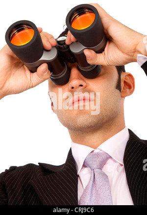 Businessman looking up through binoculars Banque D'Images