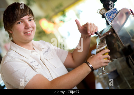 Jeune Serveur encombrement beer Banque D'Images