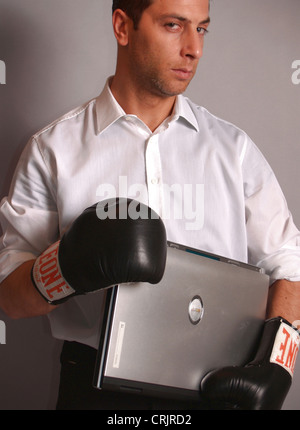 Young Woman smiling wearing boxing gloves Banque D'Images