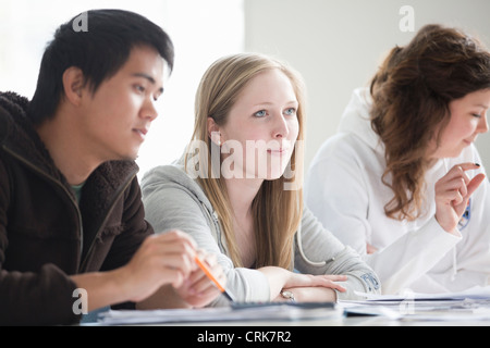 Students sitting at desk in class Banque D'Images