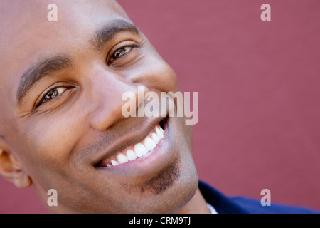 Portrait de l'inclinaison d'un happy African American man sur fond coloré Banque D'Images