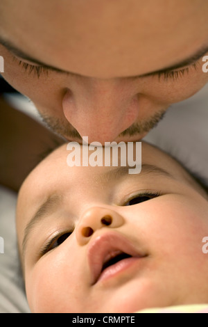 Un père s'embrasser son bébé sur la tête. Banque D'Images