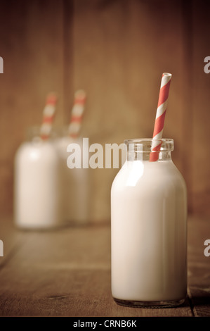 Bouteille de lait rétro rayé avec paille et d'autres bouteilles en arrière-plan Banque D'Images