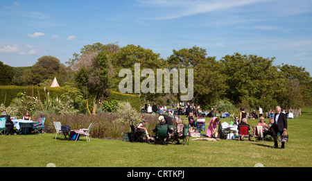 Les personnes ayant un pique-nique sur le gazon à l'opéra de Glyndebourne Festival, Lewes, dans le Sussex UK Banque D'Images