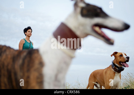 Jeune femme avec deux chiens dans la nature Banque D'Images