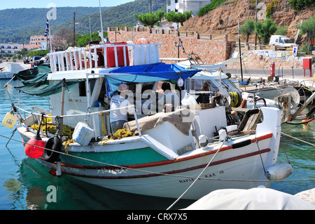 Bateau de pêche avec les pêcheurs à bord attaché jusqu'à quai dans le village de Milos, sur l'île d'Agistri, îles saroniques, Grèce Banque D'Images