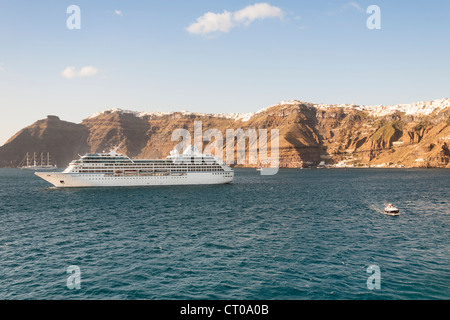 Clifftop communes d'Oia, à gauche, à droite de l'AEIE, port de Skala ci-dessous, et des navires de croisière Nautica, Santorini, Grèce Banque D'Images