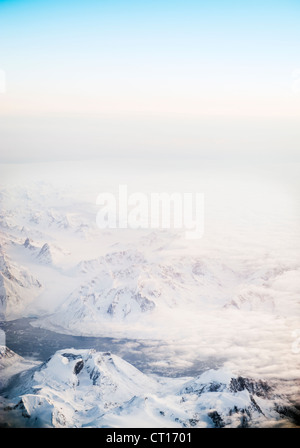 Le brouillard roulant sur les montagnes enneigées Banque D'Images