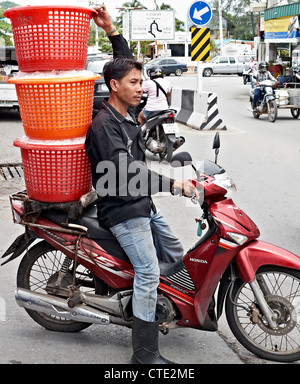 Livraison de motos en Thaïlande. Livraison de glace garçon et de la moto dangereusement surchargée. Thaïlande Asie Banque D'Images