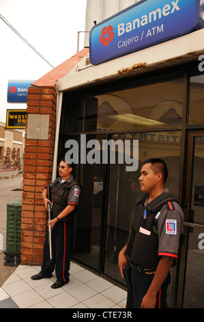 Les gardes de sécurité d'une banque garde le long de la Calle Obregon à Nogales, Sonora, Mexique, en face de la frontière de Nogales, Arizona, USA. Banque D'Images