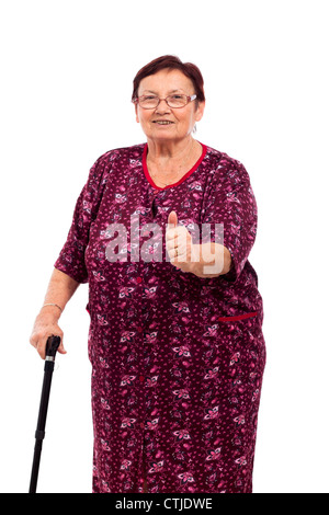 Portrait of smiling senior woman with thumb up, isolé sur fond blanc. Banque D'Images