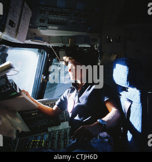 L'astronaute Sally Ride de la NASA à bord de la navette spatiale Challenger STS-7, surveille les panneaux de contrôle dans le fauteuil du pilote dans le poste de pilotage le 25 juin 1983. Ride est la première femme astronaute américain dans l'espace. Banque D'Images