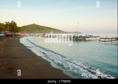 Bateaux de pêche balinaise l'ancre au large de la plage dans le village de Pemuteran en Amérique du Bali, une destination pour la plongée sous-marine et la plongée avec tuba. Banque D'Images