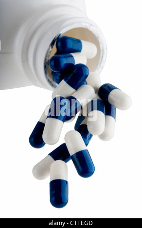 Capsules bleu et blanc qui tombe hors de prescription bottle Banque D'Images