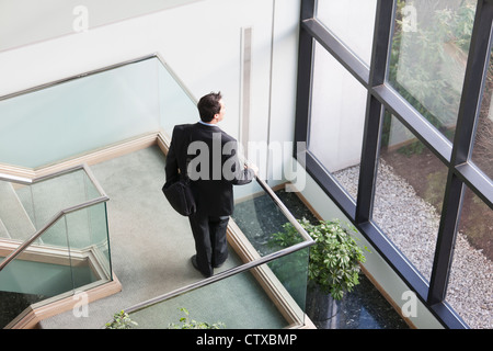 Businessman with briefcase dans les escaliers du bâtiment de bureaux Banque D'Images