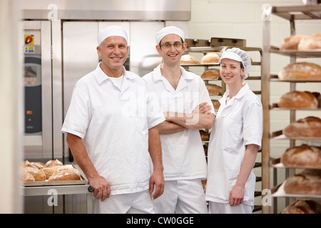 Chefs smiling together in kitchen Banque D'Images