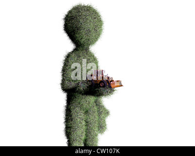Homme d'herbe avec jouet bulldozer Banque D'Images