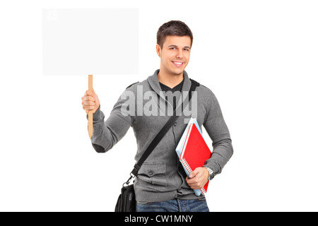 A smiling young student holding a blank banner isolés contre fond blanc Banque D'Images