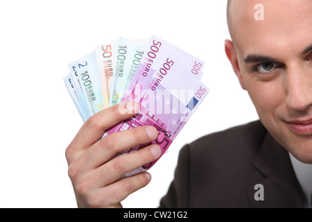 Man holding up billets Banque D'Images