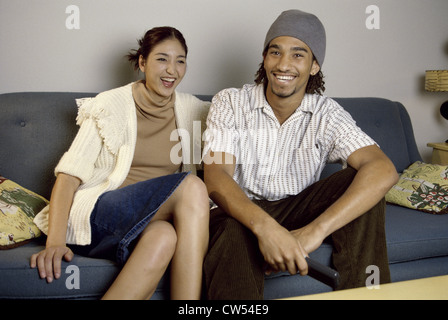 Jeune couple watching television Banque D'Images