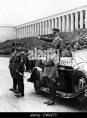 NUREMBERG, ALLEMAGNE--Chancelier Hitler (debout en voiture) salue les membres du corps des travailleurs comme theymarched par lors d'un examen Banque D'Images