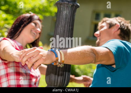 Playful couple having fun in the park happy smiling love Banque D'Images