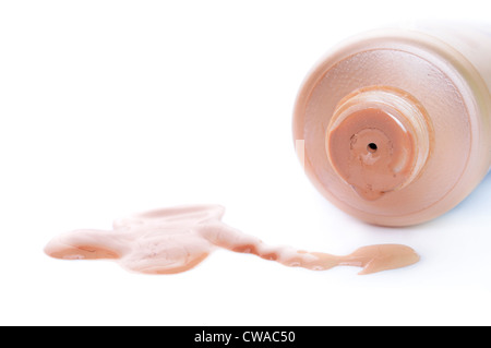 Close-up d'ouvrir le tube de crème de toner et versé de l'beige crème. La faible profondeur de champs. Se concentrer sur l'avant du tube. Assez de place pour le texte. Banque D'Images