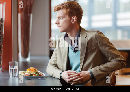 Homme assis dans un restaurant prenant le déjeuner Banque D'Images