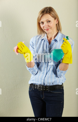 Studio Shot of Young Woman Holding Produits ménagers Banque D'Images