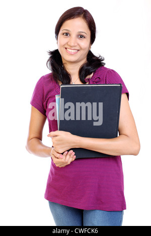 Jeune Indien female student holding books against white background Banque D'Images